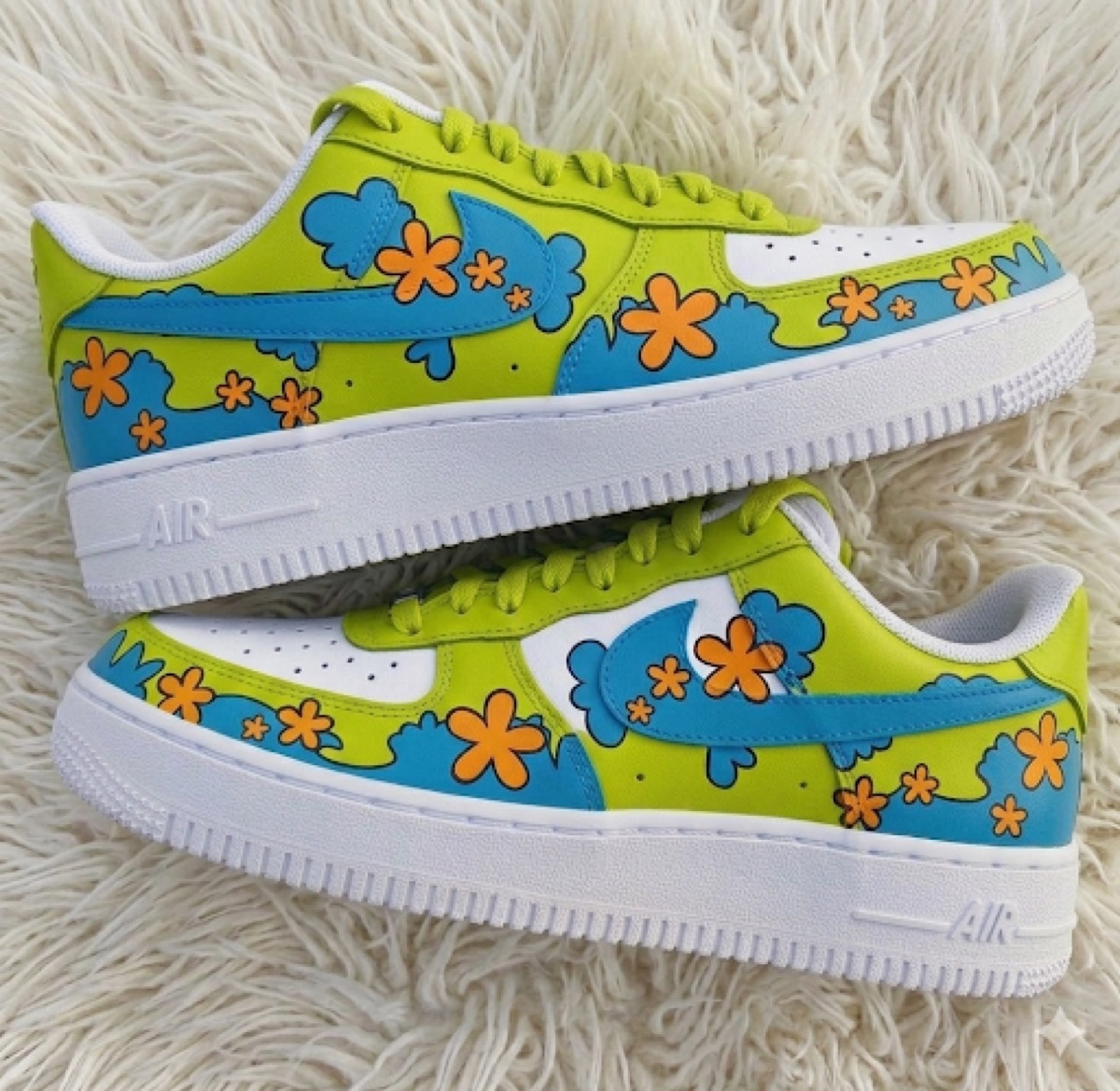 Cartoon mystery-van florals — lime and blue Air Force 1s with orange flowers